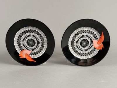 pair of black and white plates with orange fish on them