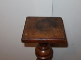 a small wooden table with a wooden top on a wooden floor