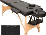 a close up of a massage table with a black cover