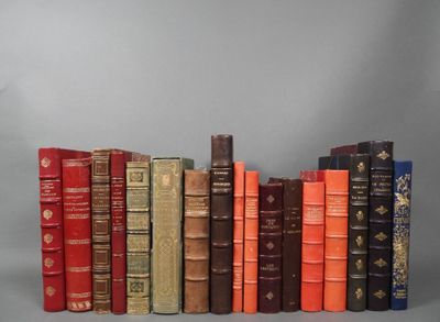 several old books are lined up in a row on a gray background