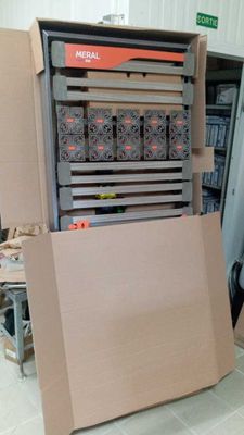 a cardboard box that is sitting on the floor next to a machine