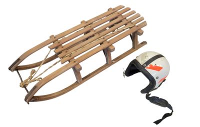 a sled with a helmet attached to it and a helmet attached to the sled