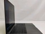 a laptop that is sitting on a white surface