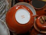 many plates and cups in a basket on the table