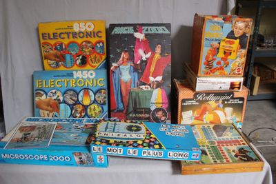 a lot of old toys on a table with a white cloth