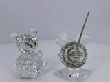 two crystal figurines of mice on a white table