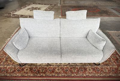 a couch that is sitting on a rug in a room