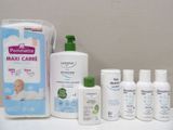 bottles of baby care sitting on a counter top next to a bag of diapers