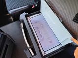 a person opening a cooler in the back seat of a car