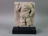an image of a stone sculpture of a man carrying a child