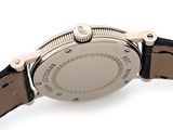 a close up of a watch on a white surface