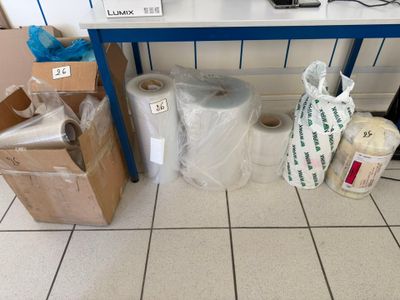 many rolls of toilet paper on the floor next to a table