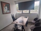 a room with a table, chairs, and a picture on the wall