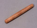 a wooden stick that is laying on a table
