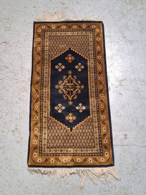 a rug on the floor with a blue and gold design