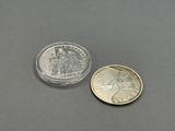 a close up of a coin and a small coin on a table