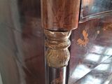 a close up of a wooden cabinet with a metal handle