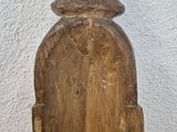 wooden sculpture of a man with a hat on top of a wooden table