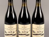 trois bouteilles de vin posées sur une table l'une à côté de l'autre