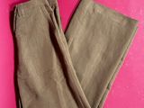 a pair of khaki pants on a pink background