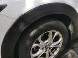 a picture of a white car parked on the side of the road