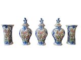 four vases with different designs are lined up against a white background