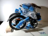 a small dog sitting on top of a blue motorcycle