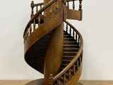 a wooden sculpture of a spiral staircase on a table
