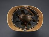 an old helmet with a leather band and a metal buckle