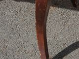 a chair that is sitting on the pavement in the parking lot