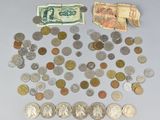 a pile of coins and money on the table