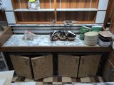 a kitchen counter with many dishes and bowls on it