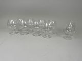 several empty wine glasses sitting on top of a white table