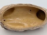 a close up of a small object on a white surface