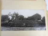 an old photo of a group of men standing in front of a train