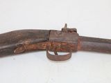 an old gun with a wooden handle on a white surface