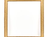 an antique gold frame with a white background