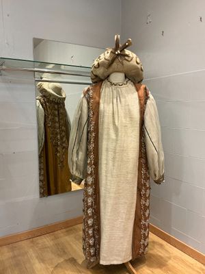 un mannequin dans un coin d'une pièce où un miroir est accroché au mur