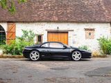 a black sports car parked in front of a building