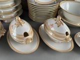 a lot of plates and bowls that are on the table
