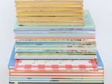 a stack of children ' s books sitting on top of each other