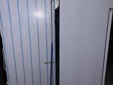 two white refrigerators in a room next to each other