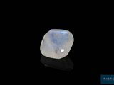 a white moons stone on a black surface