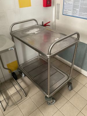 a metal table with a metal tray on it in a room