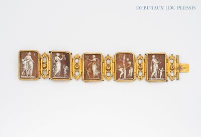 an image of a gold bracelet with a picture of a woman and a man
