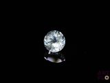 a close up of a white diamond on a black surface