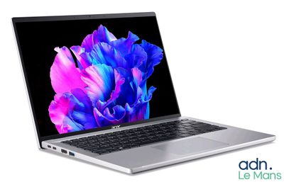 an open laptop computer sitting on top of a white surface