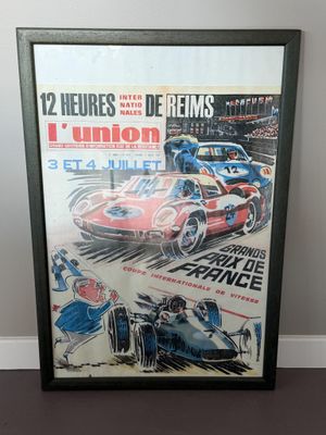 framed poster of a race car and a man on the track