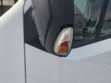 an image of a side view mirror of a white van