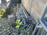 a small tree that is growing out of a pile of pipes